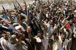 Houthi rebels brandish their weapons