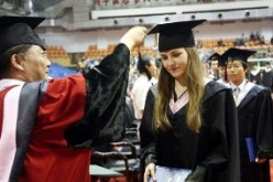 An international student graduates from a Chinese university, one among thousands who self-finance their study.