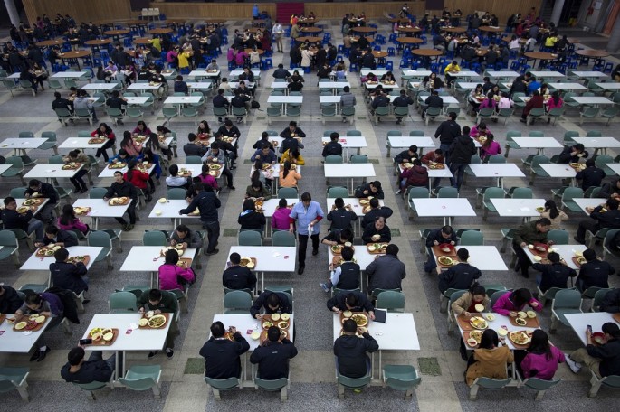 Workers eat their lunch at a restaurant inside a Foxconn factory in the township of Longhua in Shenzhen, Guangdong Province, Jan. 21, 2015.
