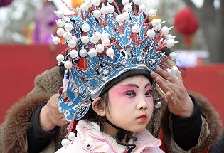 A young performer readies herself during a performance at the Lunar New Year in Taiyuan, Shanxi Province.