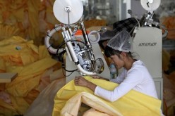 A worker at a factory making protective clothing in Weifang in Shandong Province.