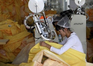 A worker at a factory making protective clothing in Weifang in Shandong Province.