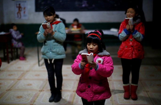 Students read a lecture from Mao Zedong's "Little Red Book" at a school in Sitong town, Henan Province. 
