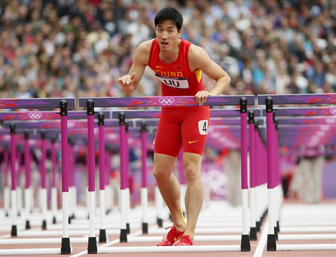 China's Liu Xiang looks up after kissing the last hurdle in his lane during his men's 110-meter hurdles round 1 heat at the London 2012 Olympic Games.