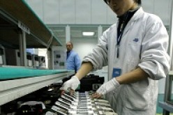 A worker tests mobile phones at a production line of Ningbo Bird Co. Ltd. in the eastern port city of Ningbo.