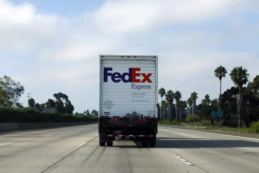 A FedEx truck makes its way to a delivery