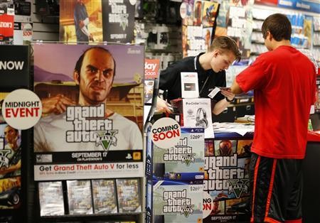A photo showing people buying the latest Grand Theft Auto V game.