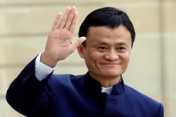 Alibaba founder and chairman Jack Ma waves to onlookers during a meeting with French President Francois Hollande in Paris, March 18, 2015.
