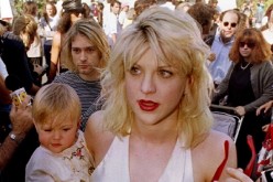 Kurt Cobain (L, behind baby), with wife Courtney Love and daughter Frances Cobain seen here in a file photo.