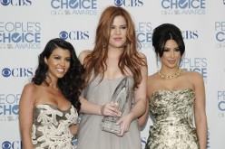 Reality television sisters (L-R) Kourtney, Khloe and Kim Kardashian pose with their favorite guilty pleasure award for 'Keeping Up with the Kardashians' at the 2011 People's Choice Awards in Los Angeles January 5, 2011