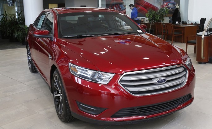 A 2015 red Ford Taurus sedan is seen in the showroom at the Suburban Ford dealership in Sterling Heights, Michigan, Feb. 6, 2015.