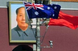 The national flags of Australia and China are displayed before a portrait of Mao Zedong in Beijing in April 2011.