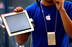 An Apple store employee gives a class on how to use the iPad 2 at an Apple Store in central Beijing. 
