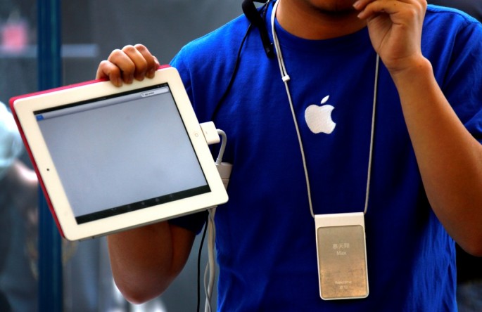 An Apple store employee gives a class on how to use the iPad 2 at an Apple Store in central Beijing. 