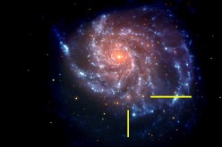 That same galaxy in a NASA Swift image is shown, with bars indicating the location of supernova SN 2011fe. The Swift image is a false-color image with UV emission blue and optical emission red.
