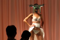 A drone takes a video of a model during a rehearsal for the 2014 China Fashion Week in Beijing. 