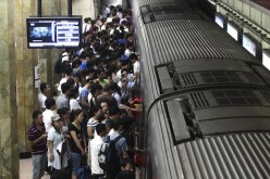 Passengers falling in line at a subway station in Beijing. Public transportation areas such as subway stations will have strengthened video security surveillance as China resists extremist attacks.