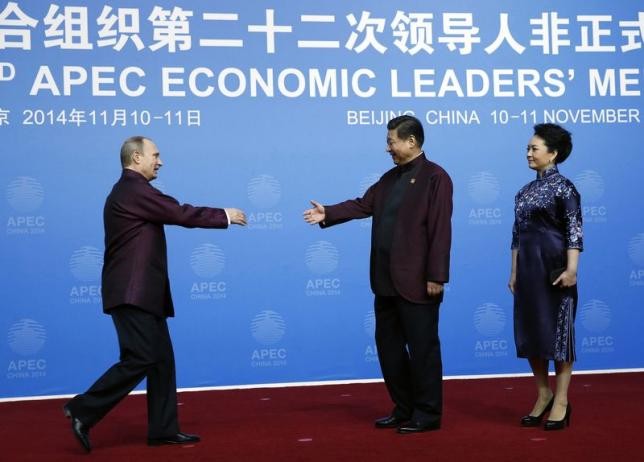 Russia's Vladimir Putin and China's Xi Jinping shake hands as a symbol of continued diplomatic ties between the two countries.