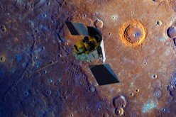 A depiction of the MESSENGER spacecraft is shown flying over Mercury's surface displayed in enhanced color. The crater ringed by bright orange is Calvino crater. The enhanced color imagery of Mercury was obtained during the mission's second Mercury flyby 