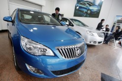 A customer looks at a Buick car at a General Motors auto dealership in Shanghai. 