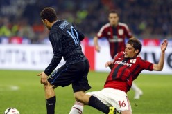 AC Milan's Andrea Poli with Inter Milan's Mateo Kovacic during their Serie A soccer match at the San Siro stadium in Milan.