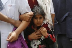 A girl holds her mother after the most devastating earthquake in Nepal on Saturday.