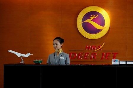 An attendant on duty at her desk inside the business jet terminal of Hainan Airline Group at Shenzhen Bao An International Airport in the southern Chinese city of Shenzhen.