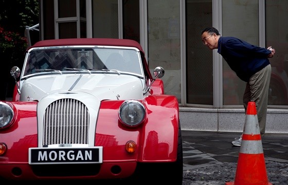 A local resident looks at a Morgan sport car during the opening of China's first Morgan sport cars showroom in Shanghai.