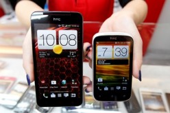 A mockup of an HTC Butterfly smartphone and a Desire C smartphone are displayed in a mobile phone shop in Taipei.