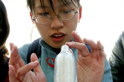 A Chinese student learns how to put on a condom at an AIDS awareness event at Tsinghua University in Beijing.