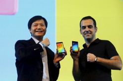 Xiaomi executives Lei Jun and Hugo Barra display Mi 4i phones during its launch in New Delhi.