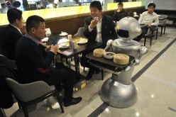 A robot delivers food orders of customers at a restaurant in Hefei, Anhui Province.
