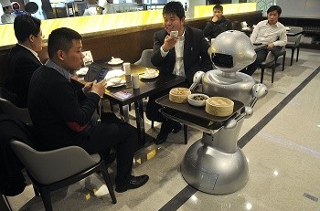 A robot delivers food orders of customers at a restaurant in Hefei, Anhui Province.