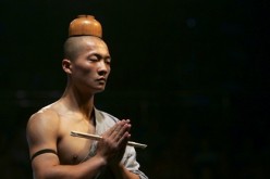 A Shaolin monk performs during a show in southwest China's Chongqing municipality.