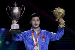 Ma Long poses with his gold medal and trophy for the men's singles final at the World Table Tennis Championships in Suzhou on May 3, 2015.