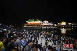 Large crowds of tourists watch the multimedia laser light show 