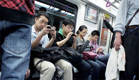 Passengers in a train try to access the Web using their mobile phones. 