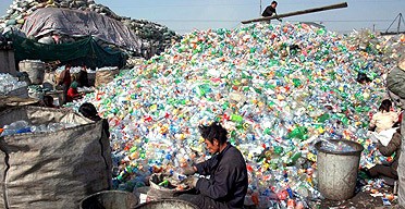 Workers sort waste materials in a recycling plant in China.