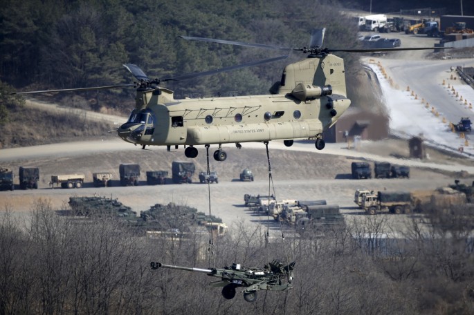 A U.S. Army CH-47 Chinook helicopter transports a howitzer during a U.S.-South Korea joint military exercise in Pocheon, South Korea, on March 25, 2015.