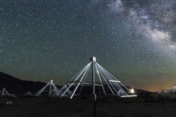 A nighttime shot of some of the antennas of the OV-LWA with the center of our galaxy in the background.
