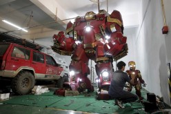 A man works on a replica of the Iron Man armor and 