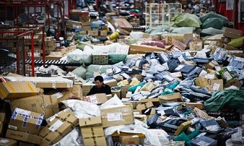A worker at YTO Express in Shanghai sorts out packages for delivery.