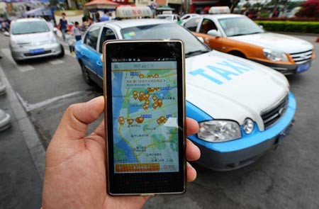 A passenger with a smartphone uses Kuaidi to hail a taxi in Xiamen, Fujian Province.