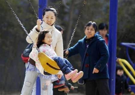 A mother bonding with her daughter in a park in Beijing.