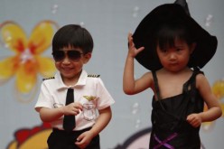 Photo taken on May 29, 2015 shows children at Beijing's Donghuamen Kindergarten putting on a fashion show to celebrate the upcoming Children's Day on June 1.