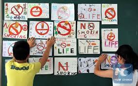 Children are posting anti-smoking banners on the wall as China's "strictest" law on smoking took effect in its capital city Beijing on June 1.
