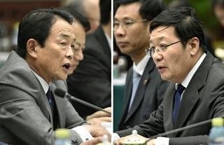 Chinese Finance Minister Lou Jiwei (at right) and Japanese counterpart, deputy Prime Minister Taro Aso (left) during the talks held in Beijing on June 6.