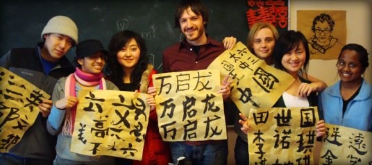 Students from other countries studying in China pose to have their pictures taken with Chinese classmates.