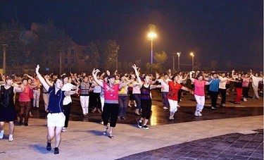 Dancing in public plaza is a common sight in many Chinese cities. 