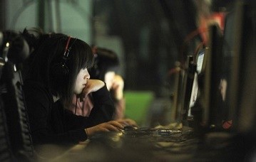 Young people seen surfing the Web at an Internet cafe in Beijing.